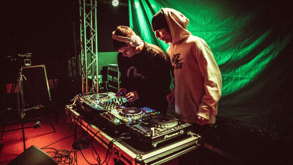 image of 2 students on a DJ deck