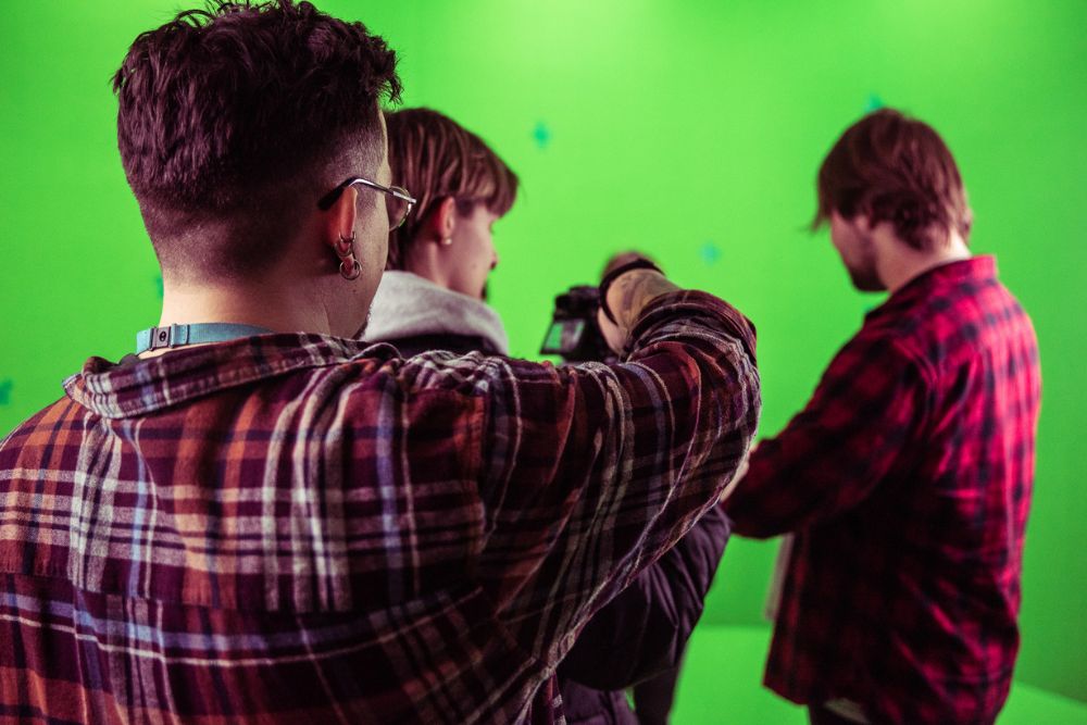 Media students using green screen studio
