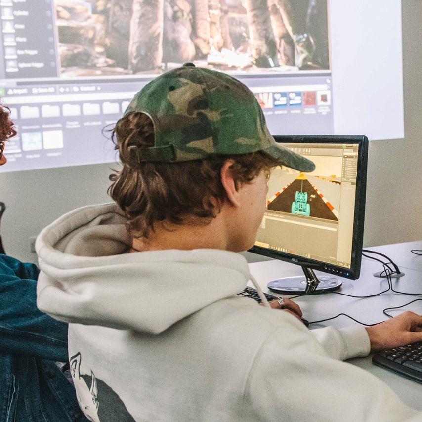 image of student on a computer working on games