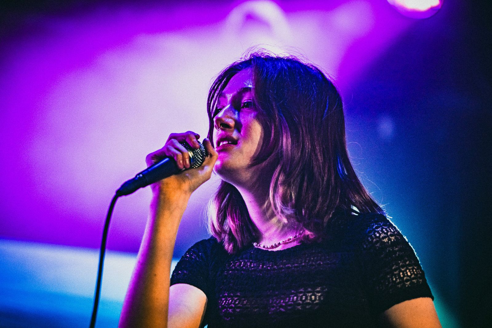 Female Access Creative Birmingham student singing in to microphone