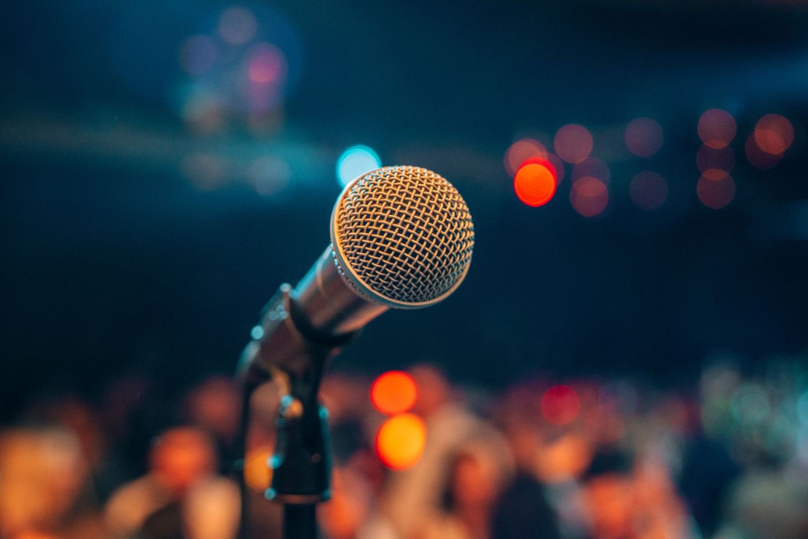 Microphone on a stage, crowd in background